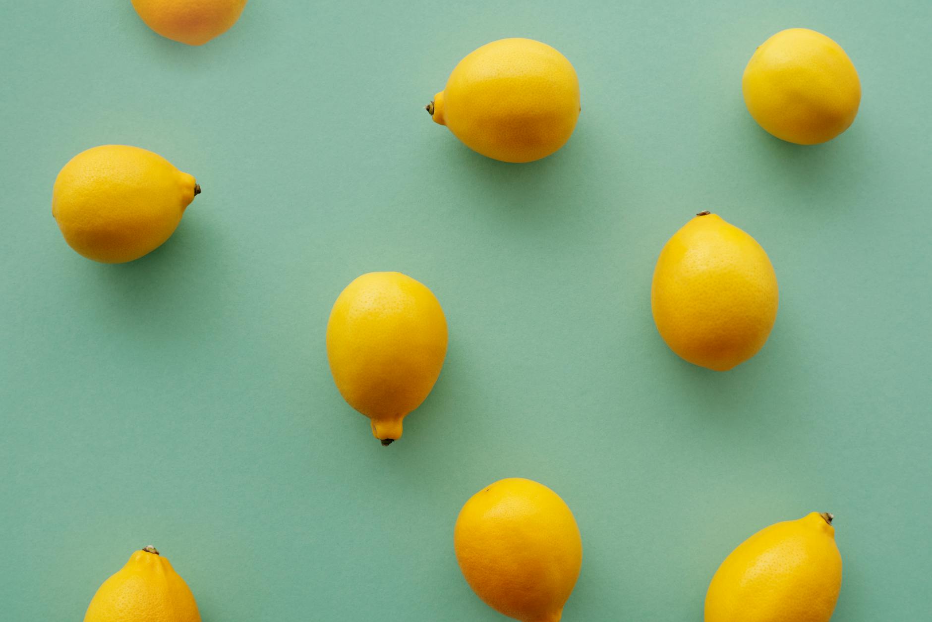 Bright yellow lemons arranged on a pastel background, symbolizing renewed sensation and pleasure