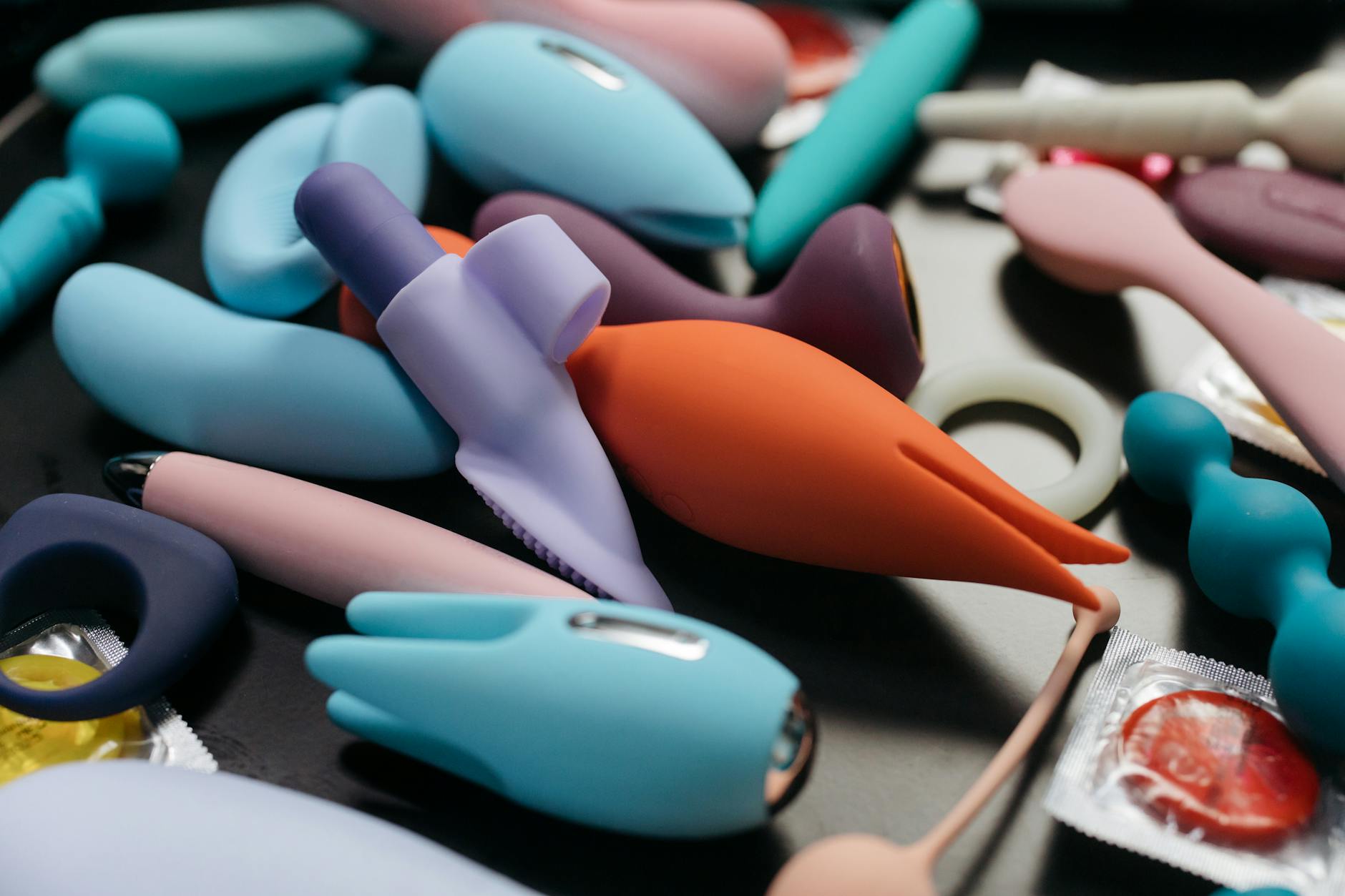 An array of vibrant adult toys including lemon clitoral vibrators in a close-up view.